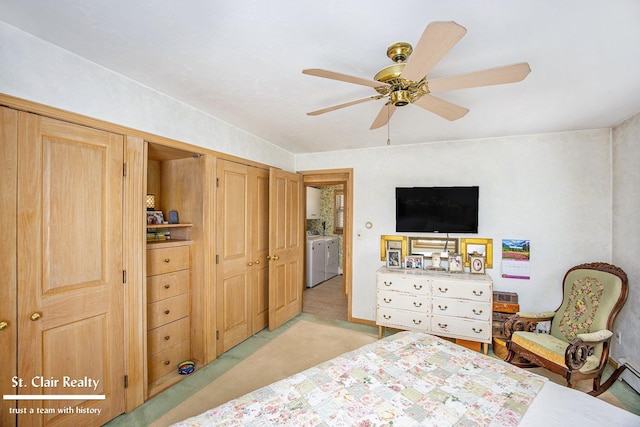 bedroom featuring a ceiling fan, light colored carpet, and washing machine and clothes dryer