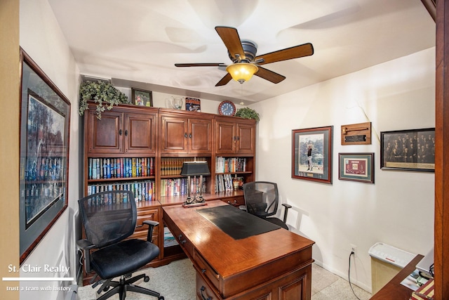 home office with a ceiling fan and baseboards