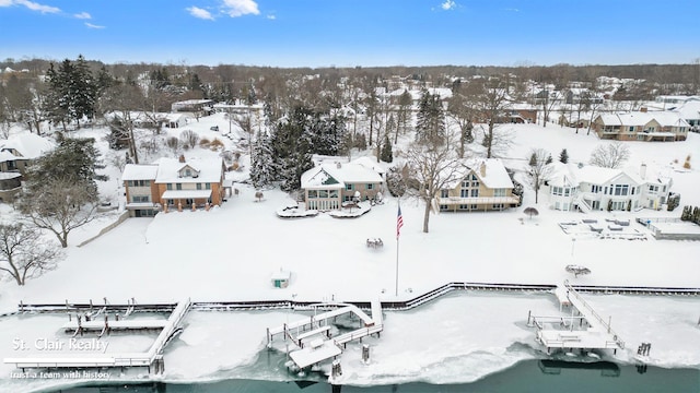 snowy aerial view with a residential view