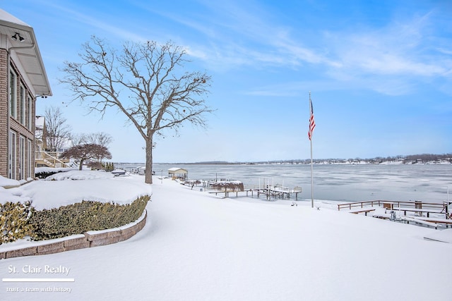 snowy yard with a water view