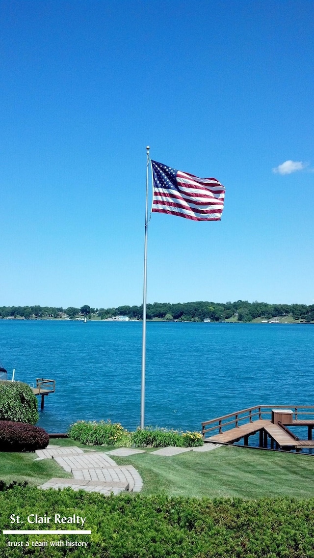 dock area with a yard and a water view