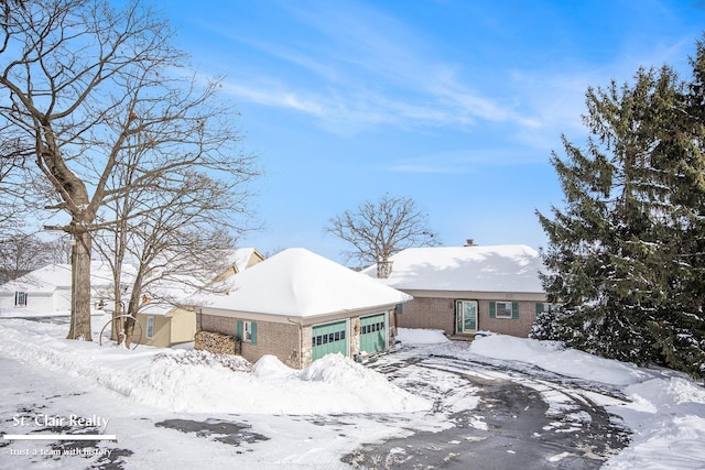 view of front of house with a garage and brick siding