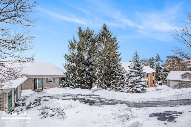 yard covered in snow featuring a garage