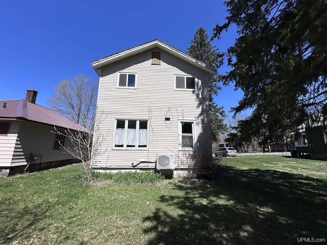 233 W Pewabic St, Ironwood, MI 49938 - rear view of house featuring a lawn and ac unit