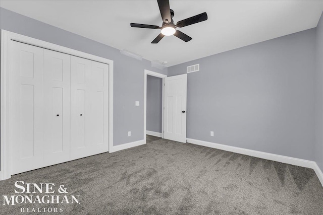 unfurnished bedroom featuring a closet, carpet flooring, visible vents, and baseboards