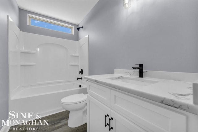 bathroom featuring shower / bath combination, toilet, wood finished floors, and vanity