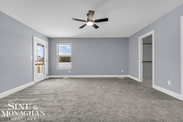 empty room with carpet floors, ceiling fan, and baseboards