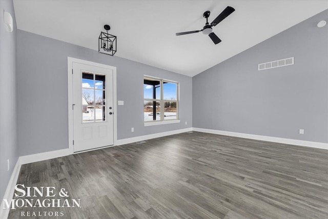 interior space featuring lofted ceiling, visible vents, dark wood-type flooring, ceiling fan, and baseboards