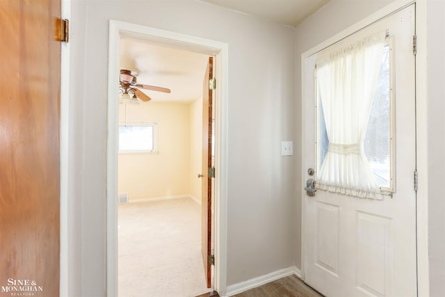 entryway featuring ceiling fan, visible vents, and baseboards