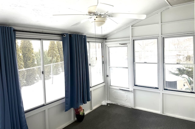 spare room with ceiling fan, vaulted ceiling, and carpet