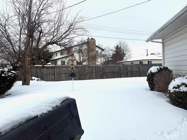 snowy yard with fence