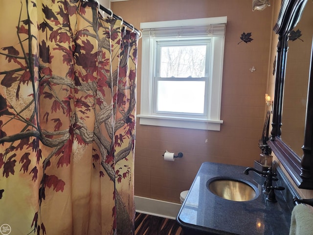 full bathroom featuring a shower with curtain, a sink, tile walls, and toilet