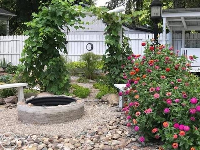 view of yard featuring an outdoor fire pit and fence