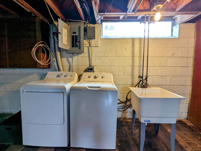 clothes washing area with laundry area, electric panel, a sink, and separate washer and dryer