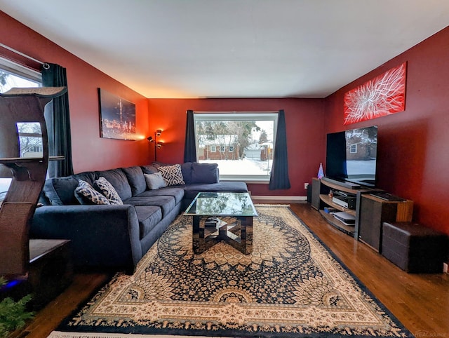 living area with dark wood-style flooring and baseboards