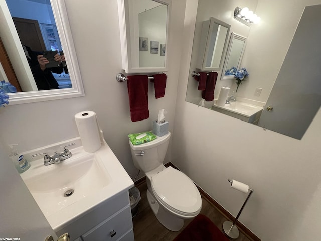 half bathroom with vanity and toilet