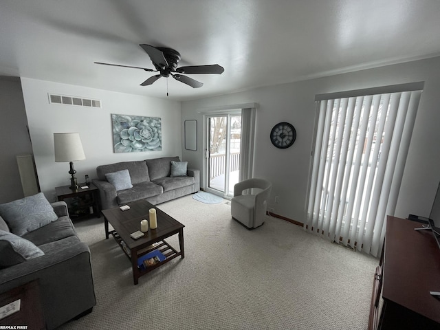 living room with carpet floors, visible vents, and ceiling fan