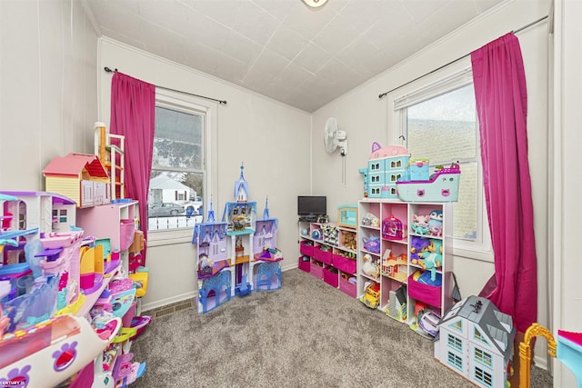 game room featuring crown molding, carpet flooring, a wealth of natural light, and baseboards