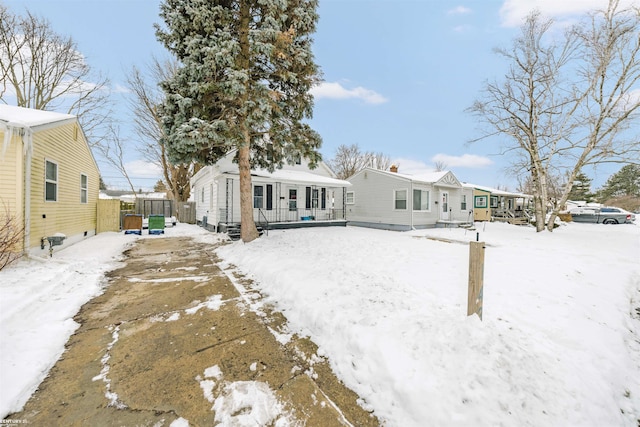 view of snow covered back of property