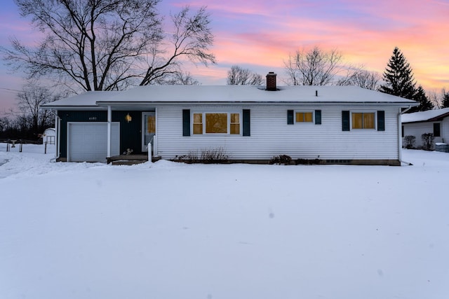 ranch-style house featuring a garage and a chimney