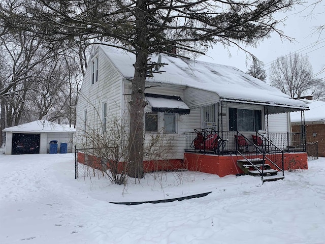 bungalow-style home featuring an outbuilding and a detached garage