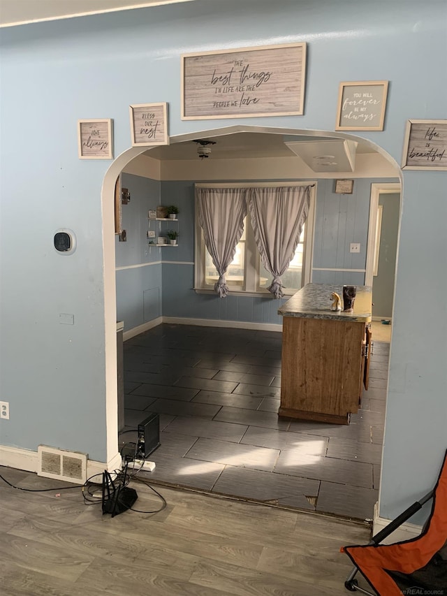 reception area featuring arched walkways and visible vents