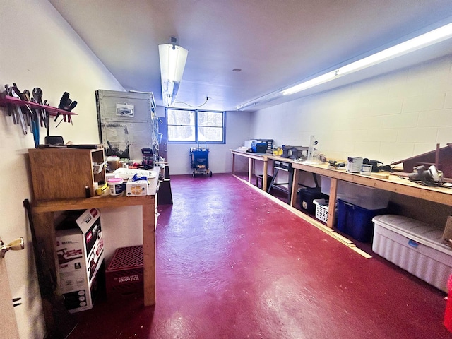 office space with concrete floors and a workshop area