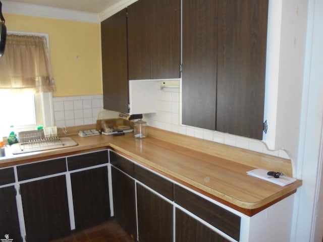 3606 Cadieux Rd, Detroit, MI 48224 - kitchen featuring tasteful backsplash, crown molding, and dark brown cabinets