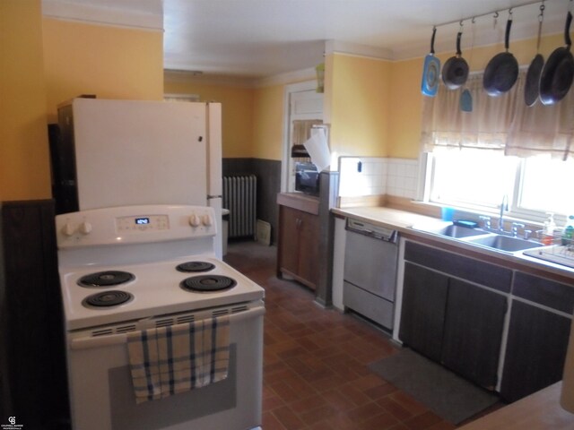 3606 Cadieux Rd, Detroit, MI 48224 - kitchen with brick floor, light countertops, radiator heating unit, a sink, and white appliances