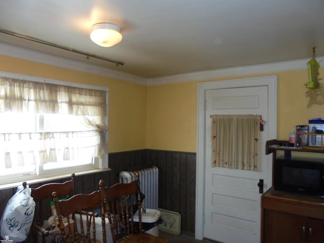 3606 Cadieux Rd, Detroit, MI 48224 - dining room with a wainscoted wall, wood walls, crown molding, and radiator
