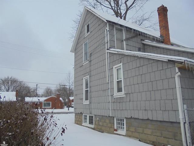 3606 Cadieux Rd, Detroit, MI 48224 - view of snowy exterior featuring a chimney