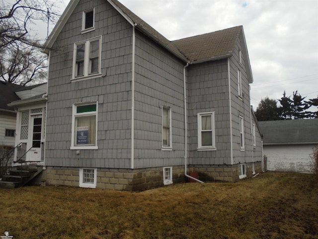 3606 Cadieux Rd, Detroit, MI 48224 - view of side of property with entry steps, a lawn, and roof with shingles