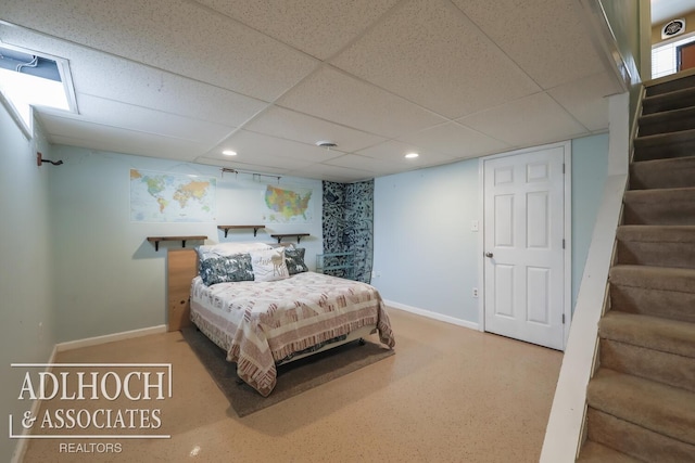 bedroom with a paneled ceiling, baseboards, and recessed lighting