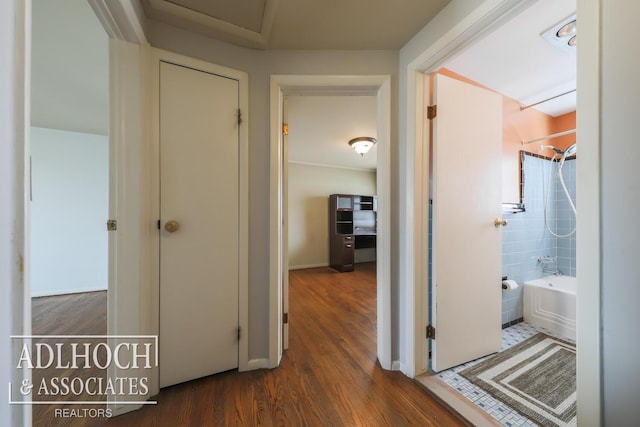 corridor featuring dark wood-style flooring