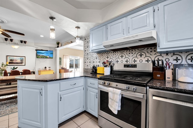 kitchen featuring light tile patterned floors, decorative backsplash, appliances with stainless steel finishes, a peninsula, and under cabinet range hood