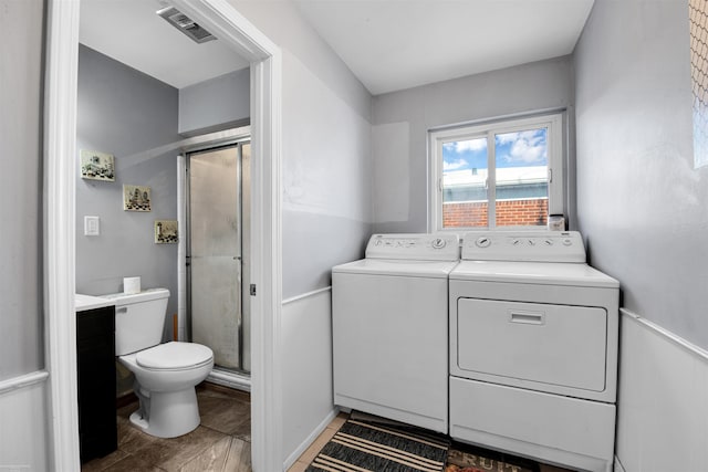 laundry area featuring laundry area, visible vents, and separate washer and dryer