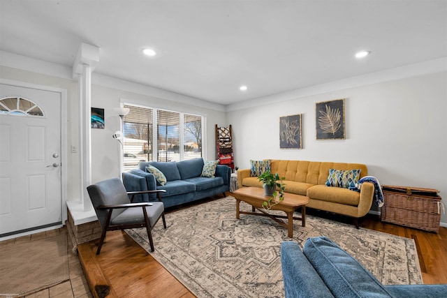 living area with recessed lighting, decorative columns, and wood finished floors