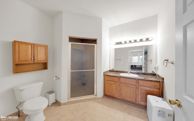 ensuite bathroom with toilet, a shower stall, connected bathroom, and vanity