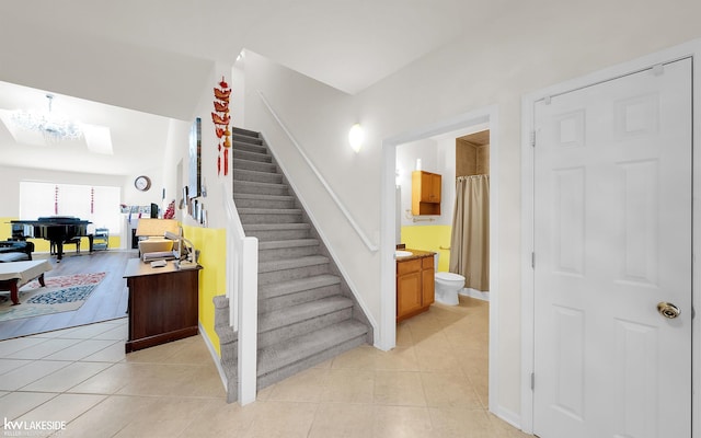 stairs featuring baseboards and tile patterned floors