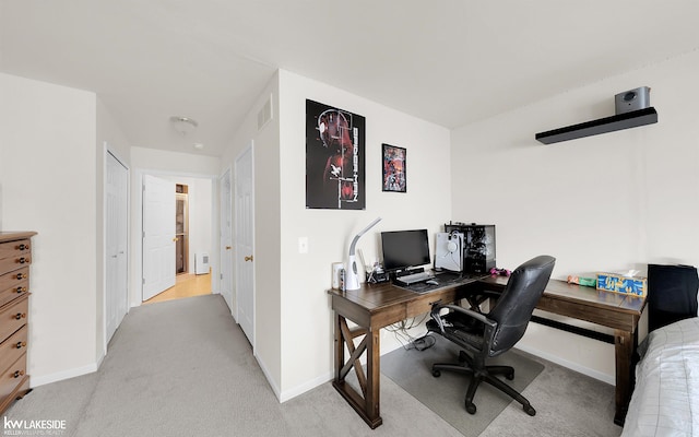 office area featuring light carpet, baseboards, and visible vents