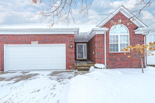 view of front of house featuring brick siding and an attached garage