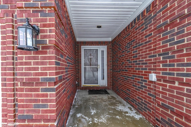 doorway to property with brick siding