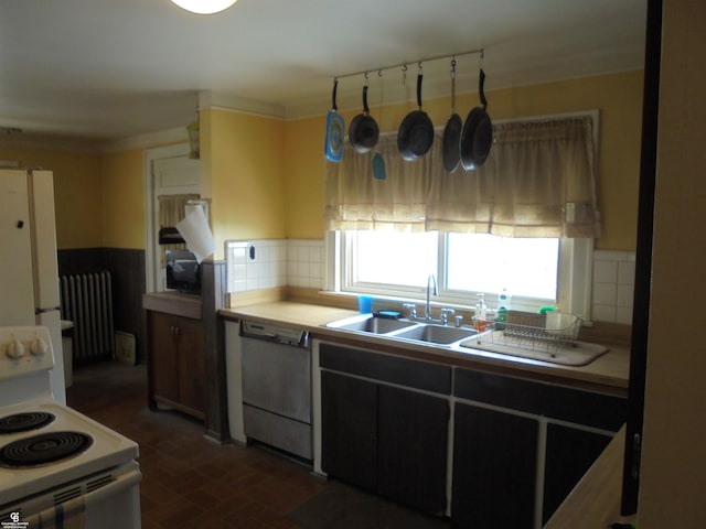 kitchen featuring radiator, white appliances, light countertops, and a sink