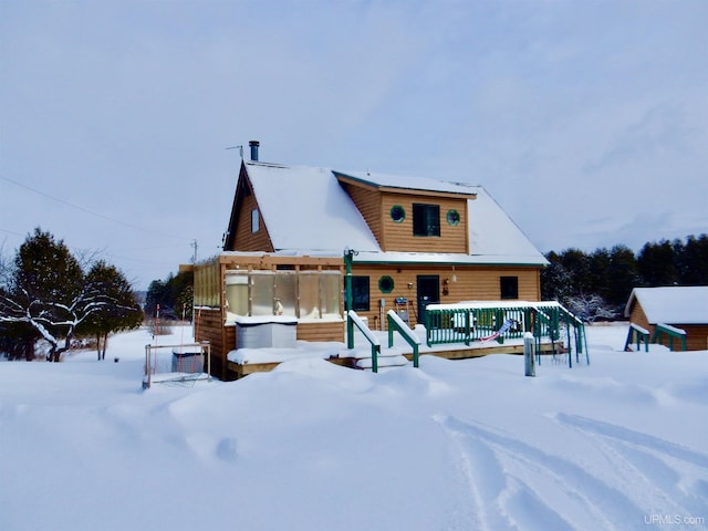 view of snow covered back of property