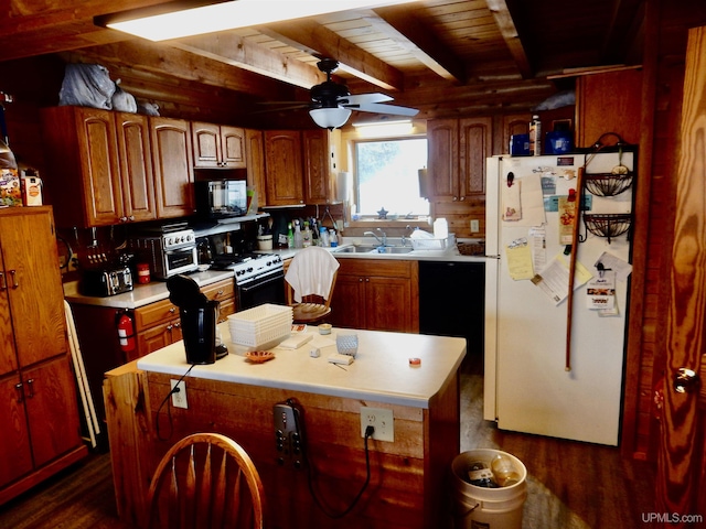 kitchen with range with electric cooktop, freestanding refrigerator, light countertops, black microwave, and a sink