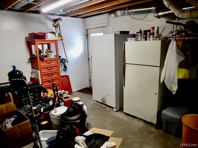 unfinished below grade area featuring freestanding refrigerator