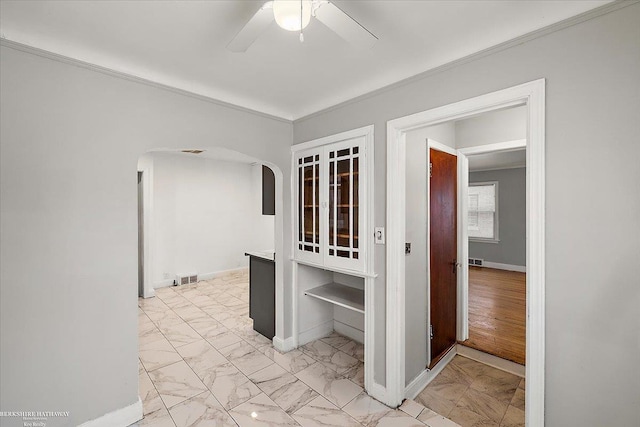 interior space with arched walkways, marble finish floor, visible vents, and baseboards