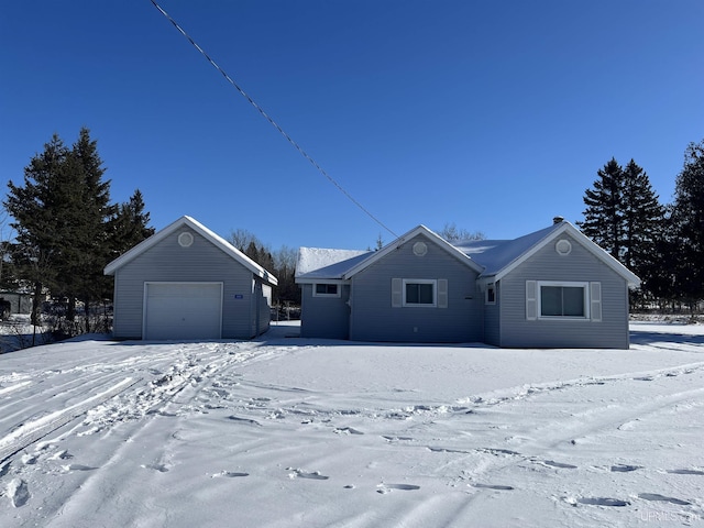 ranch-style home featuring a detached garage