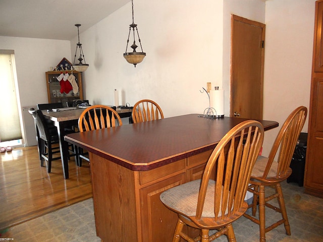 dining area featuring dark wood-type flooring and lofted ceiling