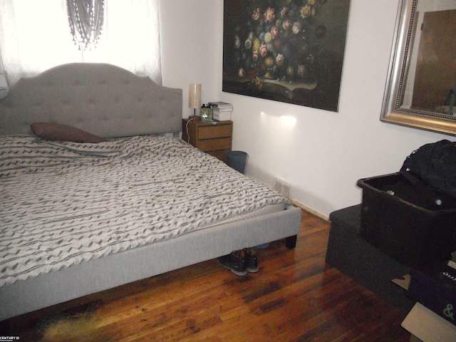 bedroom with dark wood-style floors